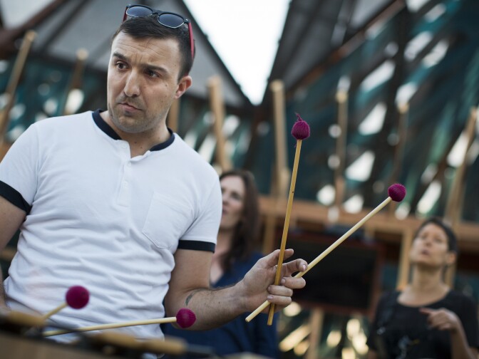 Matthew cook plays the vibraphone during a rehearsal of the mobile opera "Hopscotch" at the Central Hub in the Arts District on Friday evening, Oct. 23, 2015. Each performance lasts about 90 minutes.