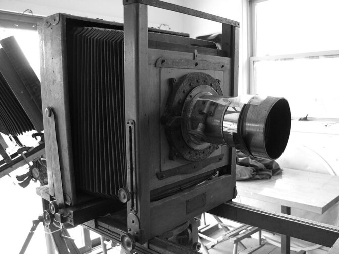 Sally Mann shoots with antique view  cameras from the early  1900s, the kind where you duck under a cloth to  take the picture. They have  hulking wooden frames, accordion-like  bellows and long brass lenses held  together with tape, with mold  growing inside. She says she loves that. It  softens the light, making the pictures timeless.