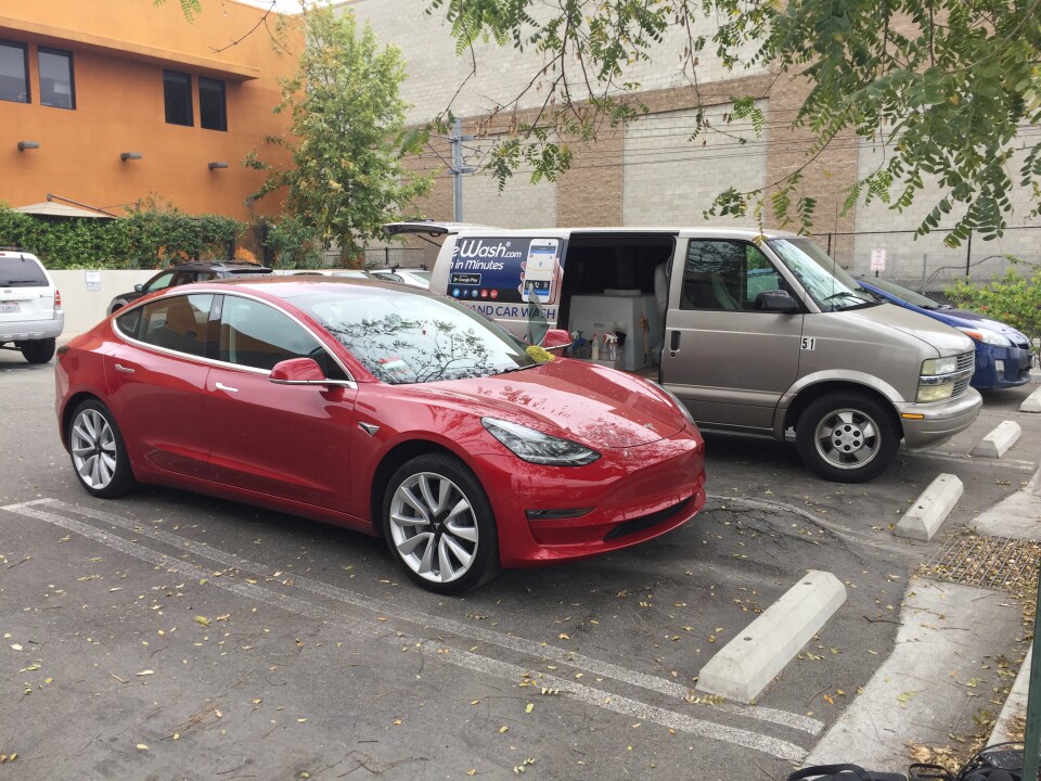 KPCC reporter Sue Carpenter's filthy car parked next to the Mobile Wash van that will clean it.