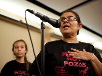 Resident Monic Uriarte of the Esperanza Community Housing Corporation speaks with her daughter, left, during a town hall meeting discussing recent findings from air monitoring and enforcement efforts related to AllenCo Energy, Inc. in the University Park. The meeting was hosted by the South Coast Air Quality Management District on Wednesday at Mount St. Mary's College.