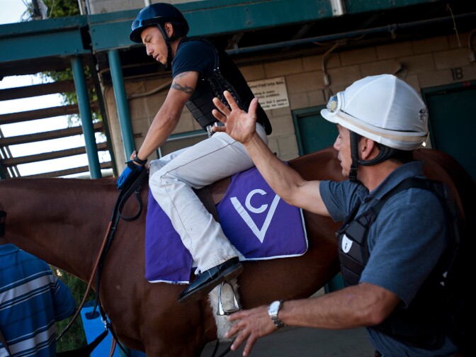 Jesse Rodriguez, left, and his father, Jesse Marquez, are exercise riders for Cerin Racing Stables. Marquez has worked for Vladimir Cerin for 30 years. Every morning riders from all the racing stables at Hollywood Park take racehorses onto the track.