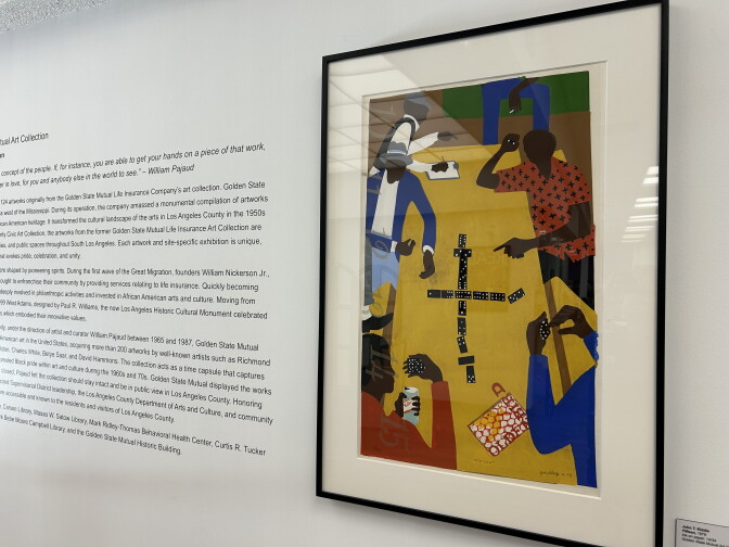 A painting shows five dark-skinned people around a table, playing dominoes.