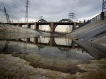 The iconic 6th Street Bridge that connects downtown Los Angeles with its eastern disticts is reflected in the Los Angeles River after its closure to traffic on January 27, 2016.
The crumbling Sixth Street Viaduct that has appeared in scores of Hollywood productions will be closed and demolished due to safety concerns after its concrete has become weakened by a rare chemical reaction. / AFP / Mark Ralston        (Photo credit should read MARK RALSTON/AFP/Getty Images)