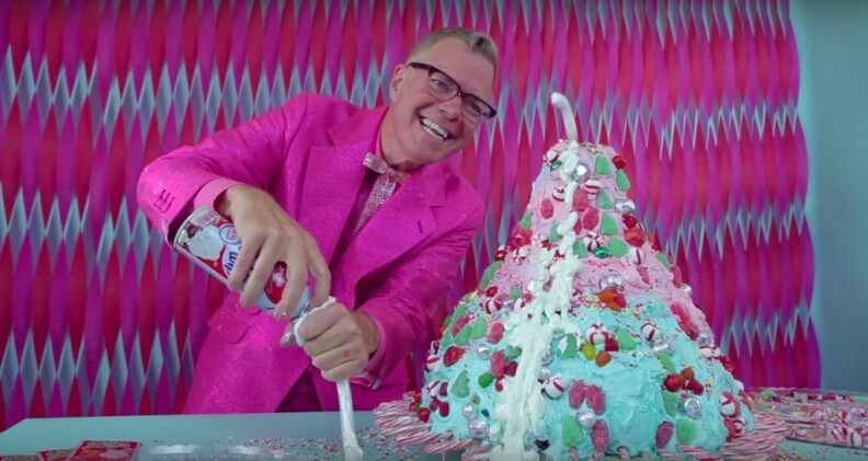 A screenshot show Charles Phoenix in the Test Kitchen with the Christmas Candy Volcano Cake.