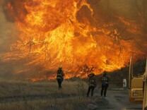 A hillside erupts in flame as a raging wildfire fire burns in Placerita Canyon in Santa Clarita, Calif., Monday, July 25, 2016. A raging wildfire that forced thousands from their homes on the edge of Los Angeles continued to burn out of control Monday as frustrated fire officials said residents reluctant to heed evacuation orders made conditions more dangerous and destructive for their neighbors.  (AP Photo/Nick Ut)