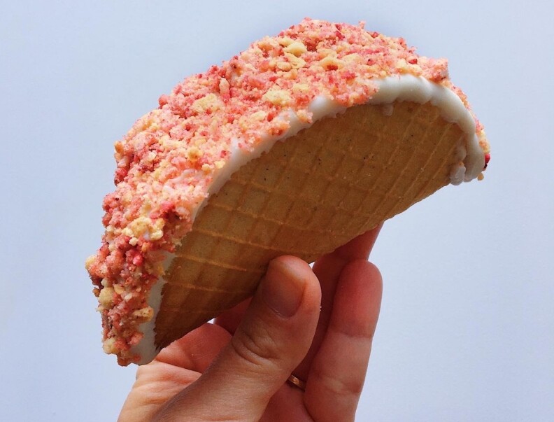 A hand holds a Strawberry Shortcake Taco from Sad Girl Creamery.