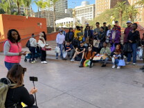 Some two dozen people stand for a group photo at Pershing Square. The group met up Thanksgiving morning, 2022, to pass out hygiene kits to unhoused Angelenos. 