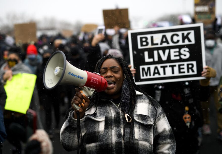 BROOKLYN CENTER, MN - APRIL 13: Protesters march outside the Brooklyn Center police headquarters on April 13, 2021 in Brooklyn Center, Minnesota. Demonstrations have become a daily occurrence since Daunte Wright, 20, was shot and killed by Brooklyn Center police officer Kimberly Potter on Sunday. Photo by Stephen Maturen/Getty Images)