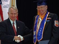 Claude Chastain Jr. of Hemet (R) who served in the U.S. Navy during World War II receives his high school diploma from Riverside County Superintendent of Schools Kenneth M. Young at the annual Operation Recognition ceremony in Moreno Valley.