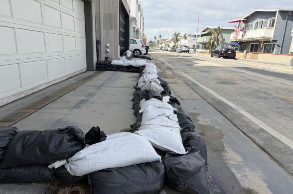 Sandbags surround a garage on a residential street of a beach town. 