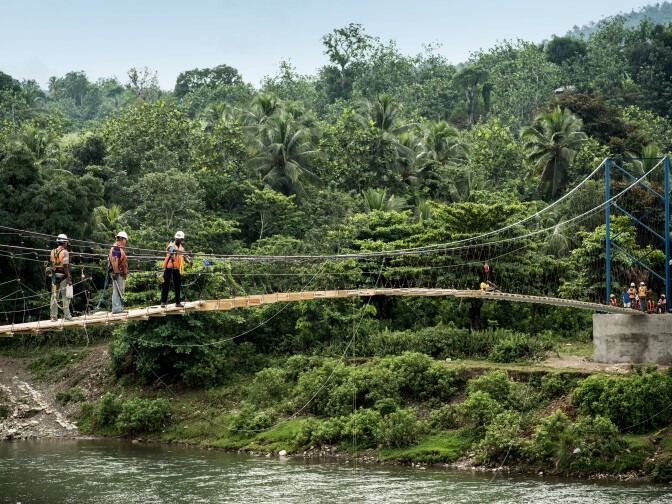 Local Haitian engineers work with engineers from the non-profit Bridges to Prosperity to build a footbridge across the Chameau River, providing access to much-needed medical care and schools.  
