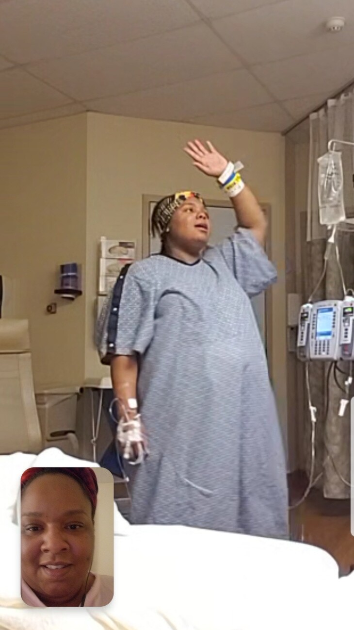 A phone screenshot shows a woman's face in the lower left corner and another woman in a blue hospital gown standing in a hospital room.