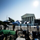 Members of the media camp outside the US Supreme Court June 21, 2012, in Washington, DC as the Supreme Court is expected to hand down its ruling.
