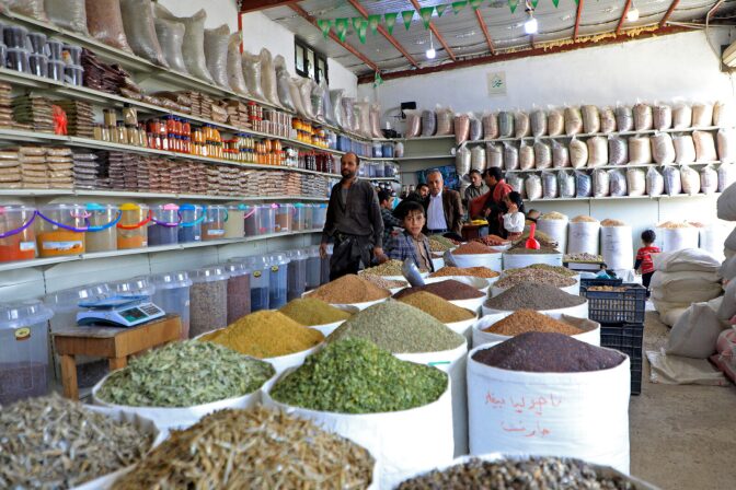 People shop at a spice and grain market in Yemen's capital Sanaa.