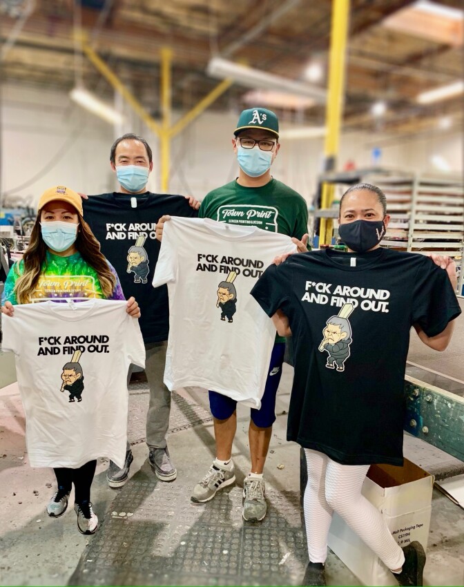 Two men and two women pose with shirts of an older Asian woman holding a wooden plank, accompanied by the words "F*ck Around And Find Out."