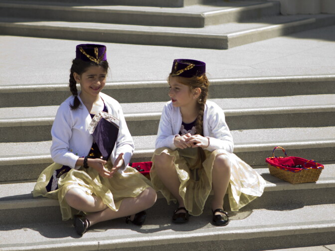 Two girls play on the steps of Pasadena City Hall after handing out commemorative black ribbons.