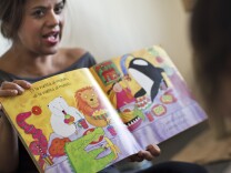 Maria Palazzolo, owner of The Family Nest in Long Beach, reads a book in Spanish during an art class on Thursday morning, Nov. 12, 2015. Palazzolo's newly launched business provides bilingual early childhood education classes.