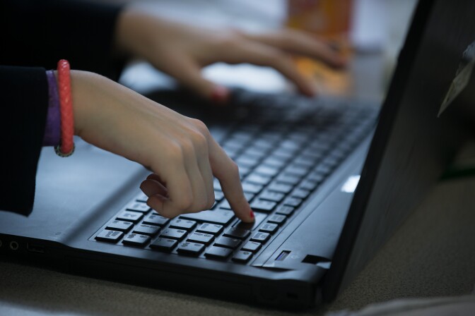 A student uses a laptop computer during a English lesson at the Ridings Federation Winterbourne International Academy.