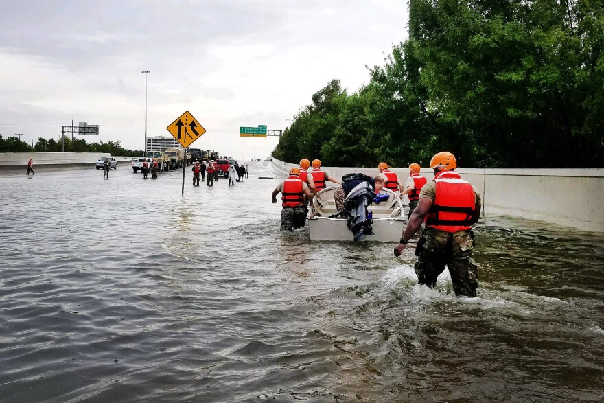 In this handout provided by the Army National Guard, Texas National Guardsmen rescue a resident by boat during flooding caused by Hurricane HarveyAugust 27, 2017 in Houston, Texas