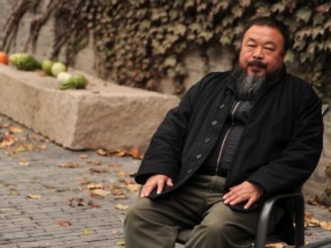 Chinese artist Ai Weiwei sits in the courtyard of his home in Beijing where he remains under house arrest on Nov. 7, 2010.