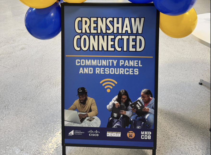 A blue sign reads, "Crenshaw Connected - Community panel and Resources" with a yellow wifi symbol below. Pictured at the bottom of the poster is a man typing on a laptop, and two women hold laptops closed in their hands. There are blue and yellow balloons tied to the top corners of the poster.