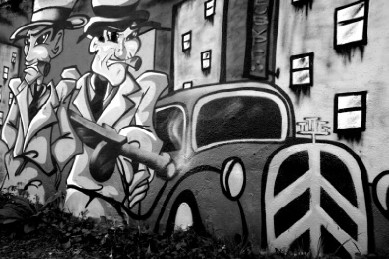 Toulouse, France - April 7, 2007: Two gangsters on a graffiti in the suburbs of Toulouse, France.