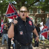TOPSHOT - A member of the Ku Klux Klan shouts at counter protesters during a rally, calling for the protection of Southern Confederate monuments, in Charlottesville, Virginia on July 8, 2017.
The afternoon rally in this quiet university town has been authorized by officials in Virginia and stirred heated debate in America, where critics say the far right has been energized by Donald Trump's election to the presidency.
 / AFP PHOTO / ANDREW CABALLERO-REYNOLDS        (Photo credit should read ANDREW CABALLERO-REYNOLDS/AFP/Getty Images)
