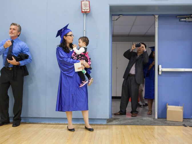Sara Farzinmehr, who is graduating in accounting and business administration, holds her duaghter before graduation at Santa Monica College.