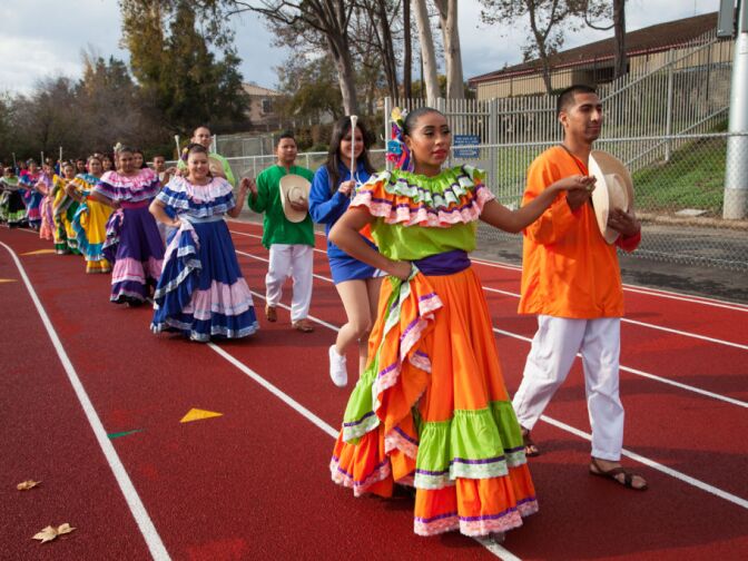 Members of El Ballet Salvador enter the football stadium at Duarte High School.