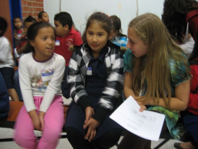 8th grader Nicole West, right, a student at Sinai Akiba Academy in West L.A. visits with second graders Melody Garcia, left, and Mercedes Torres both of Hoover Elementary near MacArthur Park.