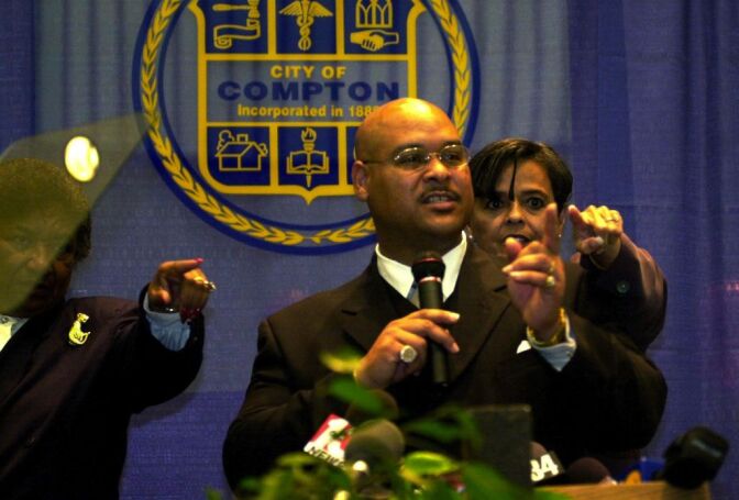 F364596 03: Compton Mayor Omar Bradley, who professes to fear for his life at the hands of some Compton Police officers, points fingers as he gives his annual "state of the city" address February 15, 2000 in Compton, California. Bradley had arrived to the previous week's City Counsel meeting with four civilian bodyguards to protect him from police. The Compton Police Officers Association has called for Bradley's recall and he has accused the police of corruption. (Photo by David McNew)