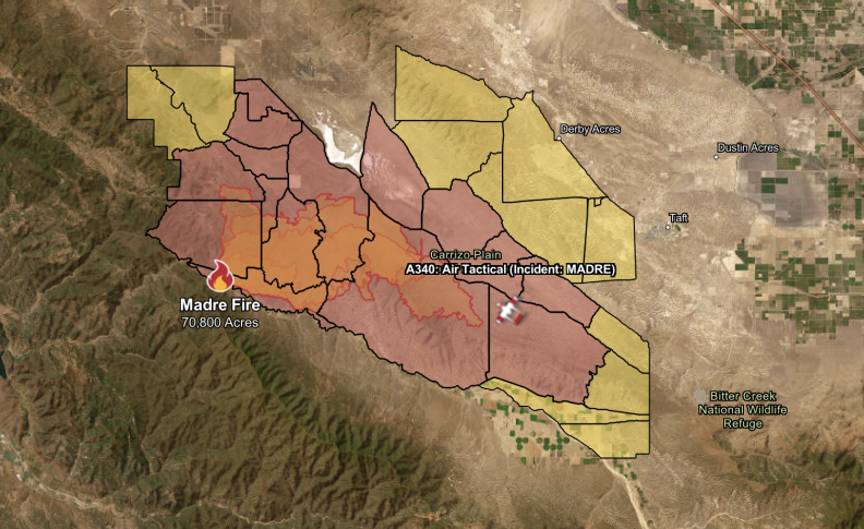 A digital map shows a red and irregular oval with a fire graphic.