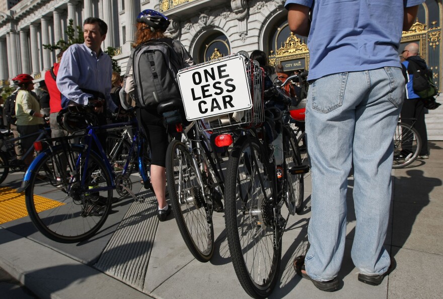SAN FRANCISCO - MAY 14:  A sign reads "one less car" on the back of a bicycle at an "energizer station" at San Francisco city hall where bicycle advocates handed out food and drink on Bike to Work Day May 14, 2009 in San Francisco, California. Over 150,000 bicyclists are expected to participate in the 15th annual Bike to Work Day event that promotes exercise and helps reduce pollution.  (Photo by Justin Sullivan/Getty Images)