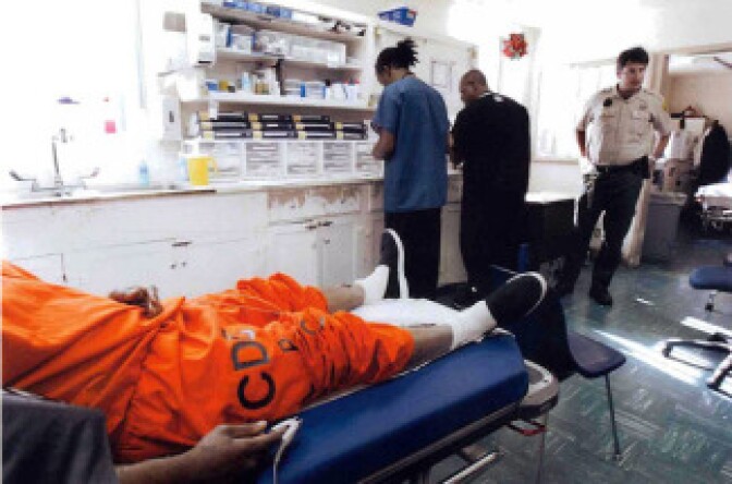 An inmate patient lies on a gurney in the Triage and Treatment Area (TTA), San Quentin's emergency room. The two bay treatment area in the Neumiller building serves the institution's more than 5,000 inmates.