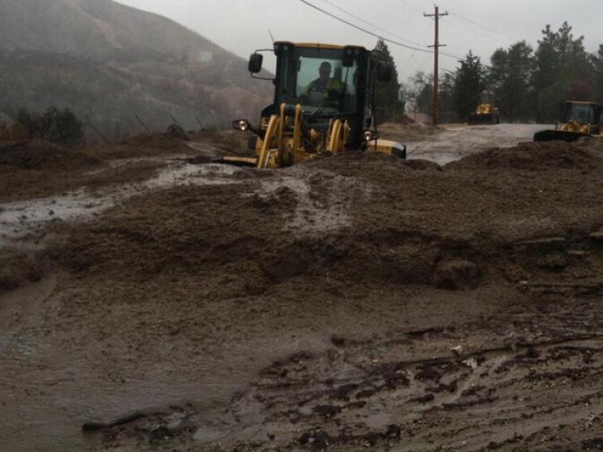 Crews from the Los Angeles County Department of Public Works use heavy equipment to clear  a mudslide from Lake Hughes Road near Castaic on Friday, February 28, 2014.