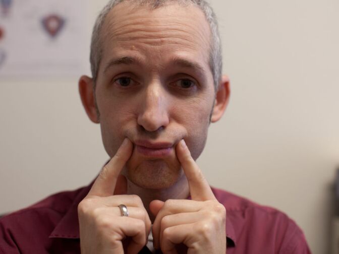 Voice therapist Robert Dowhy guides Carol Ann Susi through a series of exercises that teach her how to relax her throat muscles, use her vocal cords properly and breathe in ways that reduce voice strain.