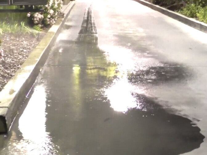 Water from sprinklers pools in the drive-up lane at the McDonalds restaurant on Bellflower Boulevard in Long Beach.