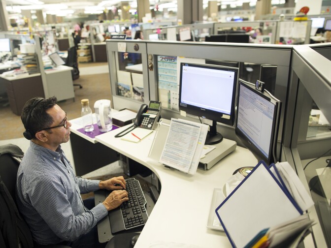 James Ayala, a children's social worker, takes calls to the Child Protection Hotline at the Metro North office of the Los Angeles County Department of Children and Family Services on Friday afternoon, April 8, 2016.
