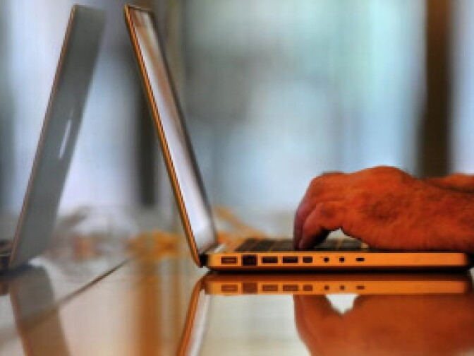 A man uses a laptop computer at a wireless cafe in Beijing.