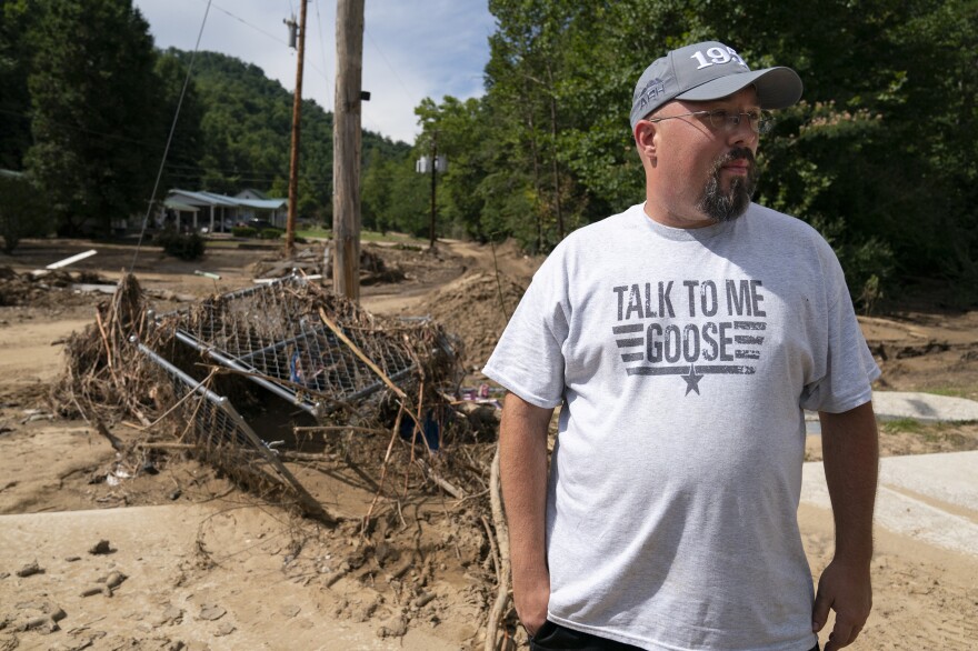 Brian Lucas inspects flood damage near his home in Isom, Ky., on Thursday.