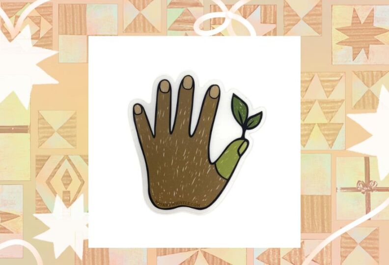 A photograph of a small sticker showing a dark-skinned hand held up so that all fingers are visible, and the tip of the thumb is green, with a little plant growing out of it, symbolizing a "green thumb." The photograph is set against a decorative taupe background accented with stars, gift boxes and strands of ribbon.