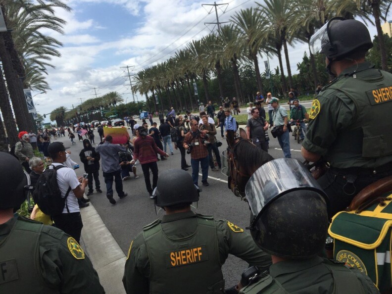 Law enforcement officers push back people near Katella/West in Anaheim following the Donald Trump rally there on Wednesday, May 25, 2016.