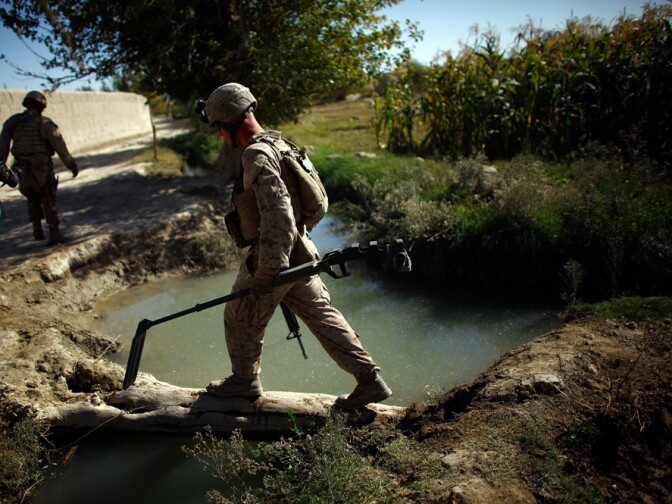 A Marine carries a metal detector near Garmsir in Helmand province in a sweep for roadside bombs. That day, Marines found and destroyed three homemade explosive devices during their six-hour patrol.
