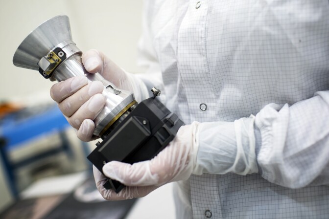 A model of a two-megapixel camera on the Juno spacecraft shows thick casing protecting the lens and sensor from Jupiter's intense radiation field.