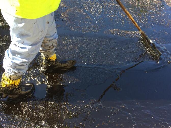 Crude oil being cleaned up on Brazil Street after an oil spill in Atwater Village on Thursday, May 15, 2014. The smell of oil was thick.