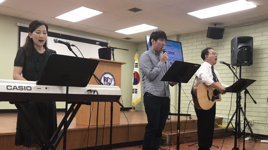 Sarah Cho accompanies her father, Pastor Young Koo Kim (left) and another church member during a recent Sunday service for the ministry they run for North Koreans.