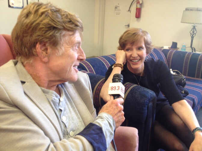 Robert Redford using Molly Peterson's microphone to interview the president of Pitzer College about climate divestment on Saturday, April 12, 2014.