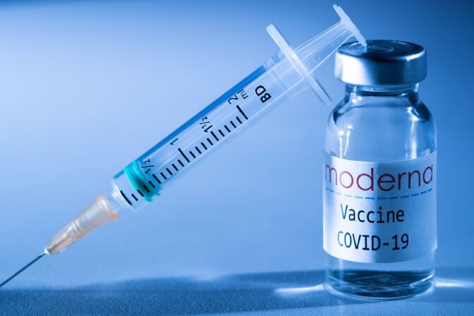 This illustration picture taken in a studio in Paris on November 16, 2020, shows a syringe and a vial with the logo of US biotech firm Moderna. - Moderna on November 16, 2020 announced its experimental vaccine against Covid-19 was almost 95 percent effective, marking a second major breakthrough in the quest to end the pandemic. (Photo by JOEL SAGET / AFP) (Photo by JOEL SAGET/AFP via Getty Images)