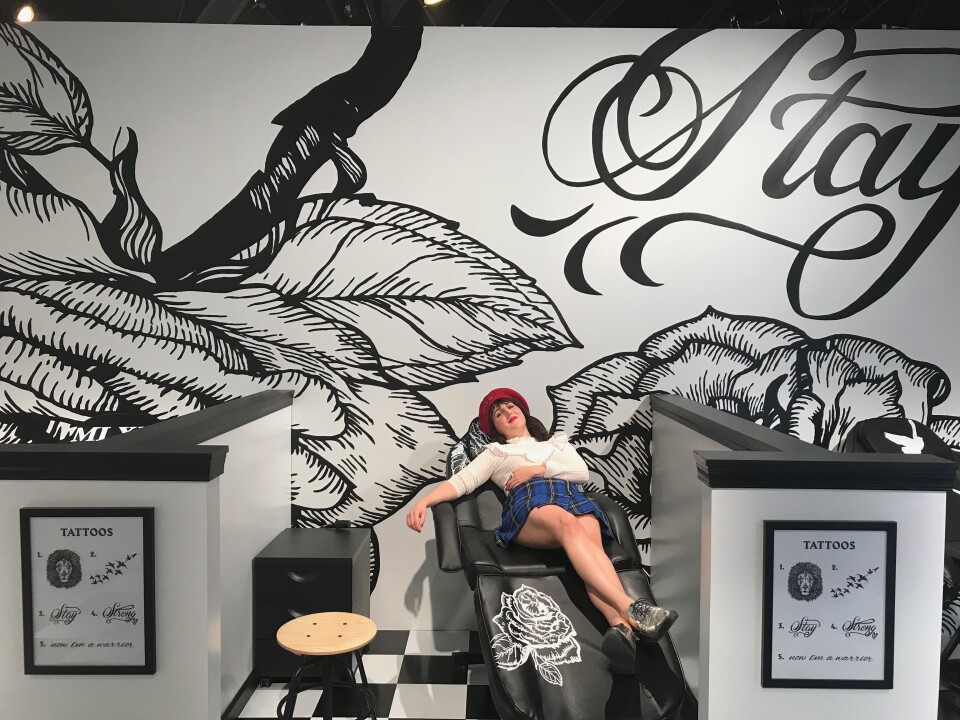 Piera Gelardi lies ready to receive a tattoo in the The Power Parlor. in collaboration with pop star Demi Lovato. Visitors can get some of Lovato’s most empowering tattoos airbrushed on. The tattoos represent strength for Lovato and she hopes her own personal journey of taking pain and turning it into art will inspire others.   Photo credit: Adriana Cargill