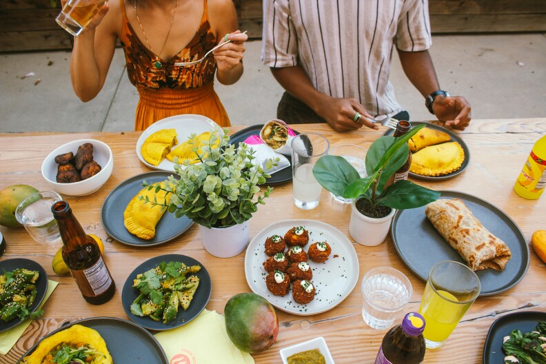 An aerial view of a table filled with dishes from Bridgetown Roti.